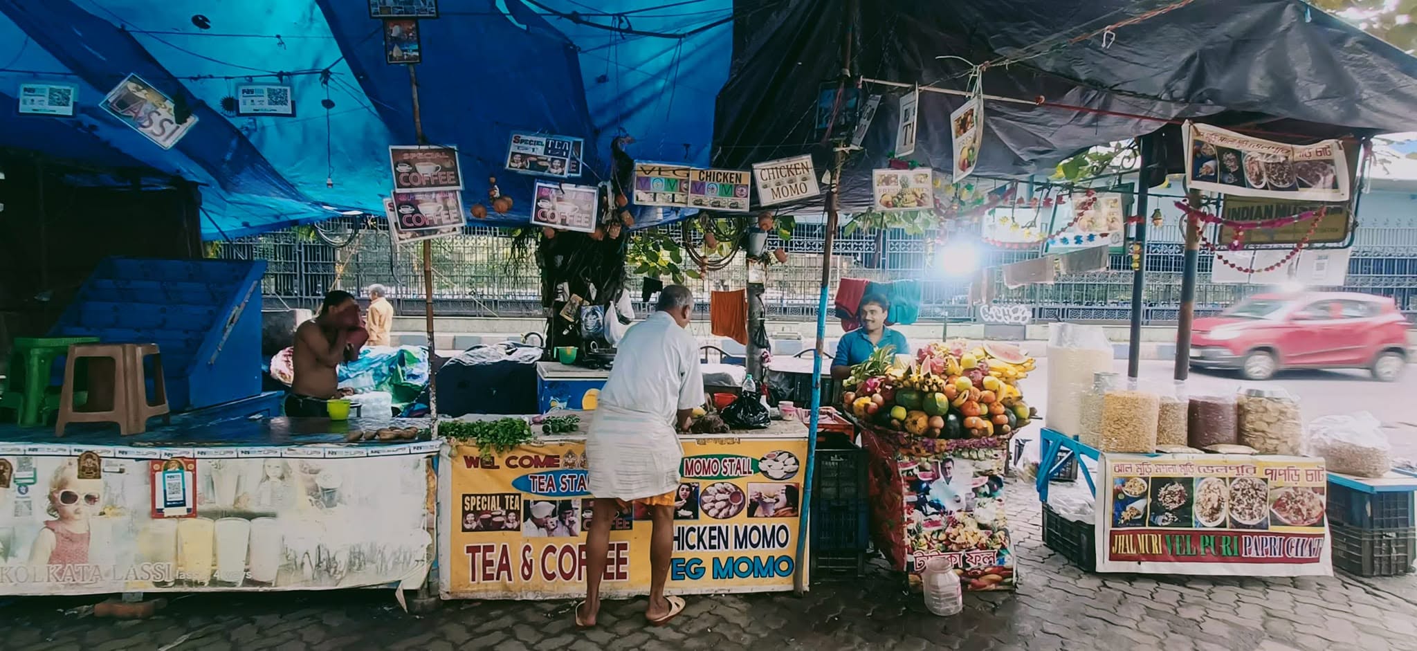 Breakfast stalls under blue tarpaulins in Kolkata